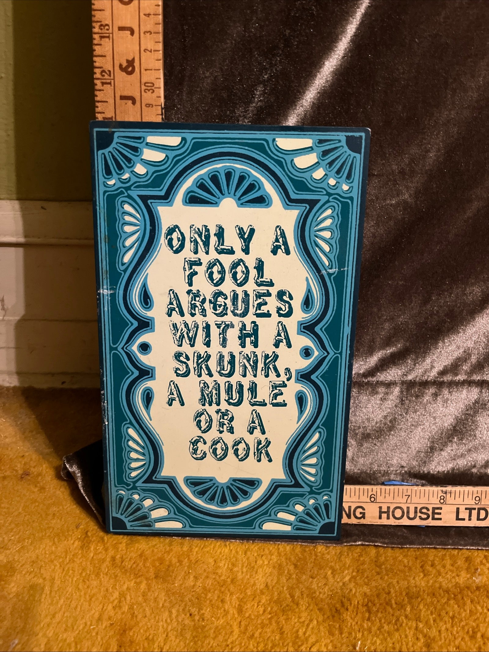 Only a fool argues with a skunk, a mule or a cook sign pf